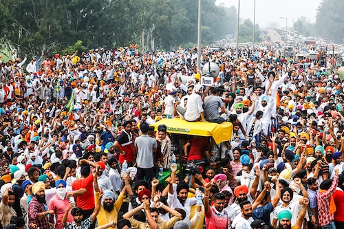 Farmers gesture as they block a national highway during a protest against farm bills passed by India"s parliament, in Shambhu in the northern state of Punjab, India, September 25, 2020.