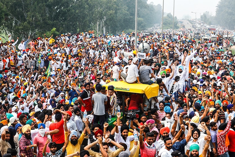 Farmers gesture as they block a national highway during a protest against farm bills passed by India"s parliament, in Shambhu in the northern state of Punjab, India, September 25, 2020.