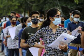 Aspirants wait to enter the examination centre to appear for JEE Advanced, at Ion Digital Zone, in Sector 62, on September 27, 2020 in Noida, India. The Joint Entrance Examination-Advanced (JEE-Adv) is being conducted across the country on Sunday, with 160,000 students likely to appear for the engineering entrance examination this year amid the coronavirus disease pandemic. The examination—organised by the Indian Institute of Technology, Delhi (IIT-D)—is being held across 222 cities and over 1,000 examination centres.