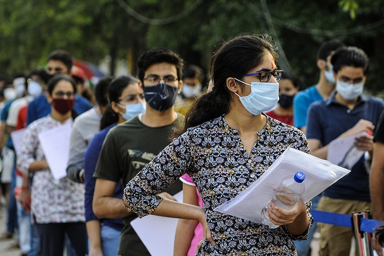 Aspirants wait to enter the examination centre to appear for JEE Advanced, at Ion Digital Zone, in Sector 62, on September 27, 2020 in Noida, India. The Joint Entrance Examination-Advanced (JEE-Adv) is being conducted across the country on Sunday, with 160,000 students likely to appear for the engineering entrance examination this year amid the coronavirus disease pandemic. The examination—organised by the Indian Institute of Technology, Delhi (IIT-D)—is being held across 222 cities and over 1,000 examination centres.