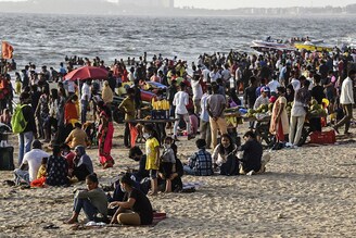 Visitors crowd at the Juhu beach amid Covid-19 coronavirus pandemic in Mumbai on April 4, 2021.