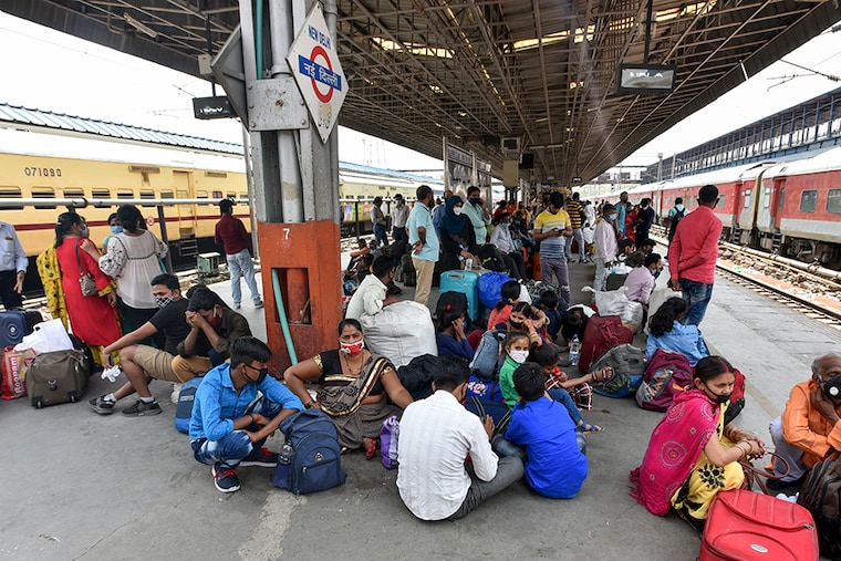 People wait for their trains to arrive at New Delhi Railway Station, after Indian Railways started 71 unreserved train services from today to increase passenger facilities, on April 5, 2021 in New Delhi, India.