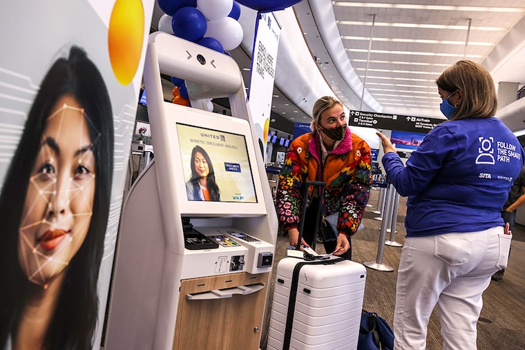 Sherry Stein (R) with SITA helps United Airlines passenger Porter Geer (L) register for SITA’s Smart Path on April 07, 2021 in San Francisco, California. San Francisco International Airport and United Airlines are partnering with information technology company SITA to trial a low-touch, biometric-enabled check-in to boarding experience for select United Airlines domestic flights. Once registered, participants in the program can check-in to flights, drop bags, pass through security and board their flight by scanning their face instead of showing identification.