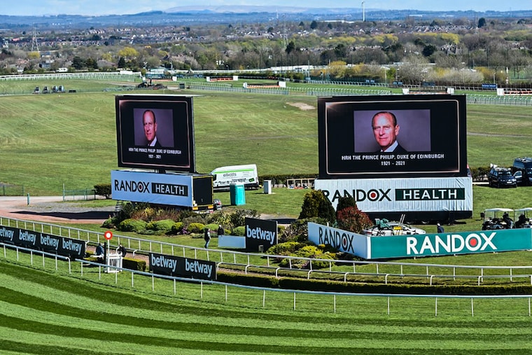 Digital screens display a picture of Britain"s Prince Philip, Duke of Edinburgh following the announcement of his death at Aintree Racecourse in Liverpool, north west England on April 9, 2021.