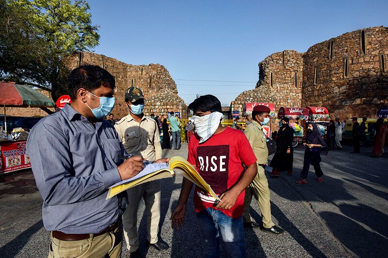 SDM officials impose fine on a visitor for not wearing face mask amid the Covid-19 pandemic, at Ferozshah Kotla Monument, on April 8, 2021 in New Delhi, India.