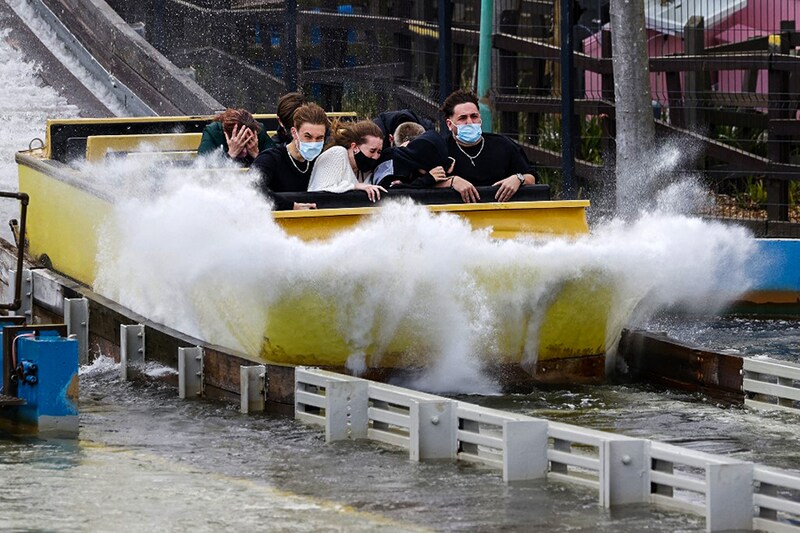 Members of the public enjoy a water ride at Thorpe Park theme park in Chertsey, southwest of London as coronavirus restrictions are eased after England"s third national lockdown on April 12, 2021. Britain was to partially lift coronavirus restrictions on Monday, reopening shops, gyms, pubs, gardens and hairdressers, while India moved to ban exports of a virus treatment drug as a record surge of cases overwhelms its healthcare system.