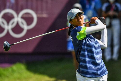 India"s Aditi Ashok watches her drive from the 1st tee in round 3 of the women"s golf individual stroke play during the Tokyo 2020 Olympic Games at the Kasumigaseki Country Club in Kawagoe on August 6, 2021. Ashok has been in the top-two after all three rounds, and a third-round 68 keeps her in position for a silver medal.