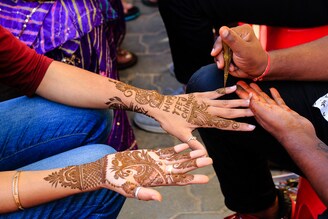 A young woman has a decorative "henna" applied on her hands on the occasion of Sinjara Teej festival in Jaipur, Rajasthan, India, on August 10, 2021. Teej celebrates the arrival of the monsoon particularly in western and northern states of India and Nepal.