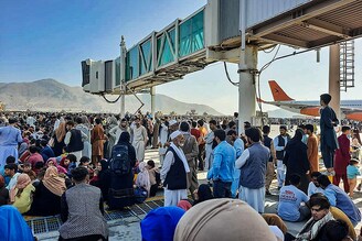 Afghan citizens crowd at the tarmac of the Kabul airport to flee the country as the Taliban took control of Afghanistan after Ashraf Ghani resigned as president and fled the country.