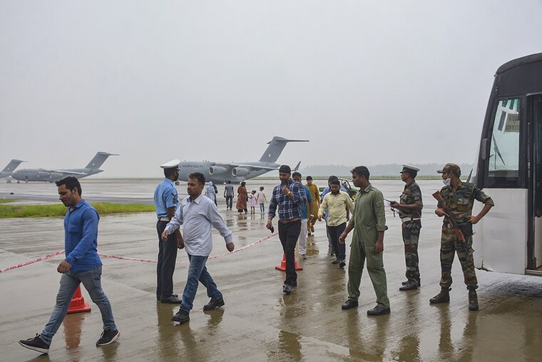 Passengers disembark from Indian Air Force"s C-17 Globemaster at Hindon Air Force Station after being evacuated from Kabul amid the Taliban takeover crisis, on August 21, 2021 in Ghaziabad, India. Indian Air Force"s special repatriation flight was carrying 168 people, including 107 Indian nationals.