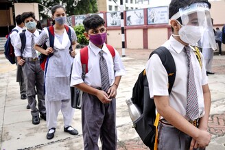 Students queue for thermal scanning before entering the classrooms on August 24, 2021 in Lucknow, India. Witnessing a dip in Covid-19 cases, schools in Uttar Pradesh re-opened for classes 9 to 12—after a gap of nearly five months"‹—while adhering to COVID-19 protocols.