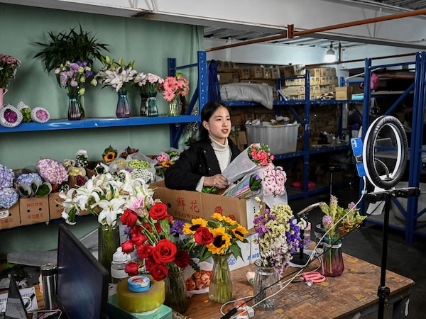 Livestreamer Cai Cai selling flowers in a makeshift studio at the Dounan Flower Market in Kunming in southwestern China"s Yunnan province Image: Jade Gao / AFP