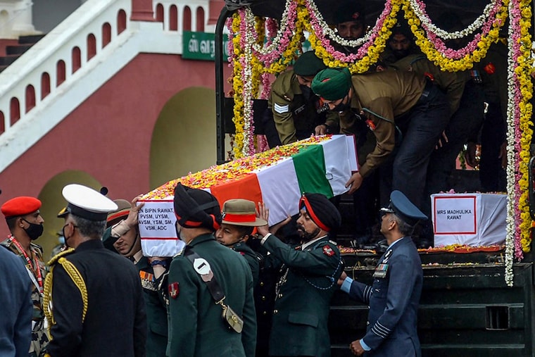 Army officers and soldiers carry the coffin containing the mortal remains of Indian defence chief General Bipin Rawat who lost his life along with 13 others a day earlier in a helicopter crash in Coonoor during a military funeral ceremony at the Madras regimental Center in Wellington, Tamil Nadu, on December 9, 2021.