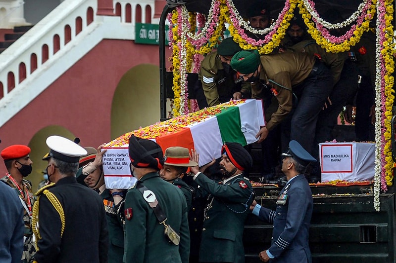 Army officers and soldiers carry the coffin containing the mortal remains of Indian defence chief General Bipin Rawat who lost his life along with 13 others a day earlier in a helicopter crash in Coonoor during a military funeral ceremony at the Madras regimental Center in Wellington, Tamil Nadu, on December 9, 2021.