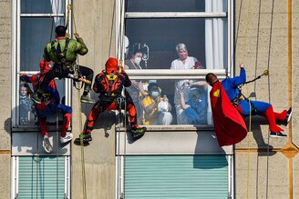 Acrobatic superheroes greet the children hospitalised in the paediatric ward of the San Paolo hospital in Milan, Italy, December 15, 2021.