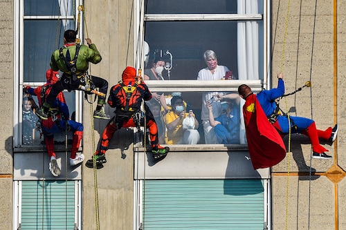 Acrobatic superheroes greet the children hospitalised in the paediatric ward of the San Paolo hospital in Milan, Italy, December 15, 2021.