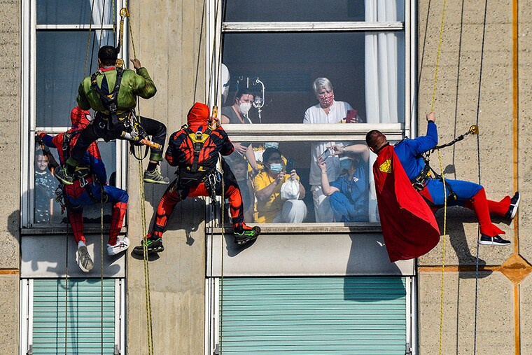 Acrobatic superheroes greet the children hospitalised in the paediatric ward of the San Paolo hospital in Milan, Italy, December 15, 2021.