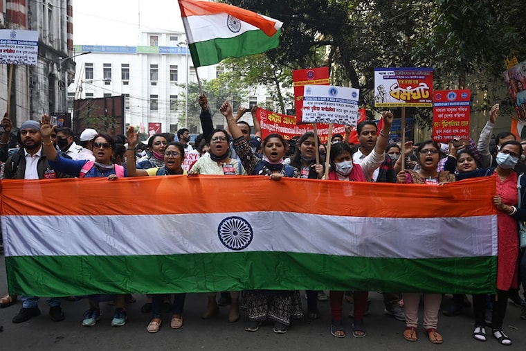 Bank employees hold national flags and shout slogans during a protest as part of two-day nationwide strike against the government"s plan to privatise public sector banks (PSBs), in Kolkata on December 16, 2021.