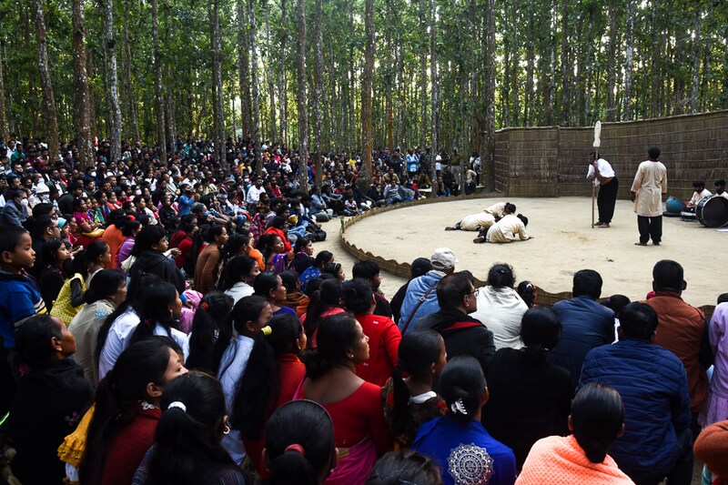 People enjoying a drama at the ongoing "Under The Sal Tree" Theatre Festival in Goalpara, Assam, India. A unique festival held in the middle of a dense Sal forest, the festival was started in 2008 by Sukracharjya Rabha, a widely respected theatre figure who wanted to spread a message of coexistence with nature.