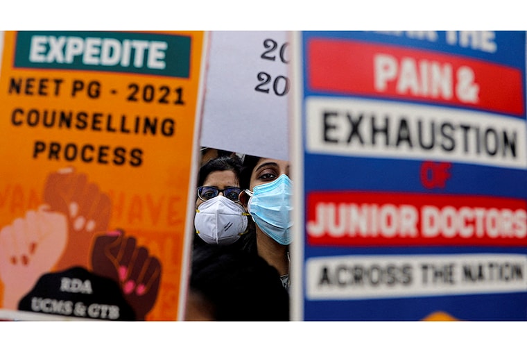 Resident doctors with Centre-run government hospitals hold placards during a protest called by the Federation of Resident Doctors" Association (FORDA) over the delay in National Eligibility cum Entrance Test Postgraduate (NEET-PG) 2021 counselling, outside Nirman Bhawan, in New Delhi, India, December 20, 2021.