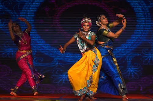 Indian actress and Bharatanatyam dancer Shobana (R) performs, along with others, at the Indian dance festival in Mamallapuram, Tamil Nadu on December 23, 2021.