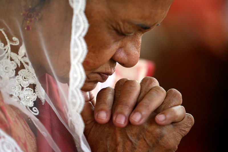 A worshipper attends a celebratory mass on Christmas at a church in Ahmedabad, India, December 25, 2021.