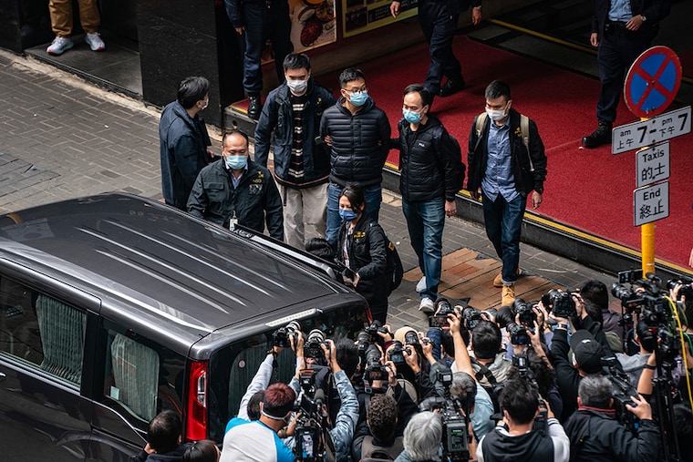 Stand News Editor-in-Chief Patrick Lam is arrested after police searched the premises of the independent news outlet office on December 29, 2021 in Hong Kong. Editors, board members and a pop singer were arrested in the early morning sweep as 200 officers raided the office.