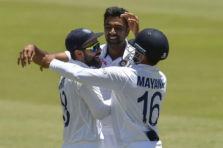 Captain Virat Kohli (L) celebrates with R Ashwin and Mayank Agarwal (R) after India won the first Test cricket match between South Africa and India at SuperSport Park in Centurion on December 30, 2021. India won the match by 113 runs.