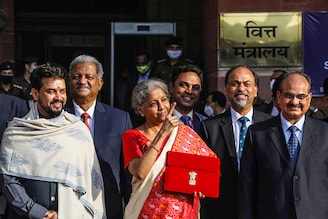 India"s Finance Minister Nirmala Sitharaman stands next to Minister of State for Finance and Corporate Affairs Anurag Thakur (L) as she leaves her office to present the federal budget in the parliament in New Delhi, India, February 1, 2021.