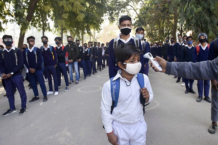 A student undergoes thermal screening before entering Model Senior Secondary School Urban Estate at Sector 4, on February 1, 2021 in Gurugram, India. Schools in Gurugram reopened for 6th to 8th standard on Monday.