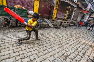 Children playing cricket on the street as schools are closed due to farmers" protest at the Tikri border on February 4, 2021 in New Delhi, India. Security at the borders, where farmers have been camping for the past two and half months to agitate against Centre"s agricultural legislation, was stepped up after thousands of protesters stormed the national capital during their tractor rally and clashes broke out between them and the police in which one farmer died while several policemen were injured.