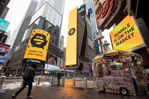 Monitors display Bumble Inc. signage during the company"s initial public offering (IPO) in front of the Nasdaq MarketSite in New York, U.S., on Thursday, February 11, 2021. Bumble Inc., the dating app where women make the first move, is targeting to raise as much as $1.8 billion from its U.S. initial public offering after boosting the size of the deal.