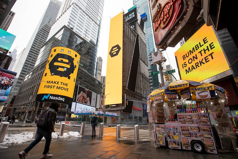 Monitors display Bumble Inc. signage during the company"s initial public offering (IPO) in front of the Nasdaq MarketSite in New York, U.S., on Thursday, February 11, 2021. Bumble Inc., the dating app where women make the first move, is targeting to raise as much as $1.8 billion from its U.S. initial public offering after boosting the size of the deal.