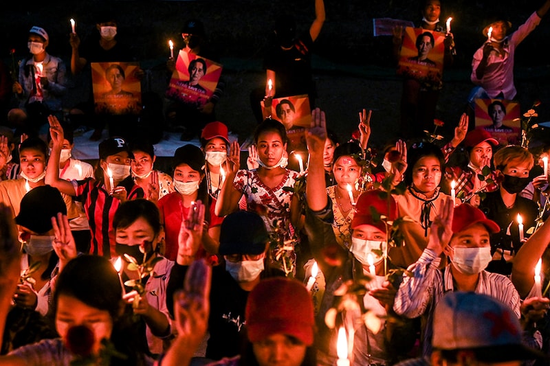 People gather during a candlelight vigil to protest against the military coup in Yangon, Myanmar, February 21, 2021.