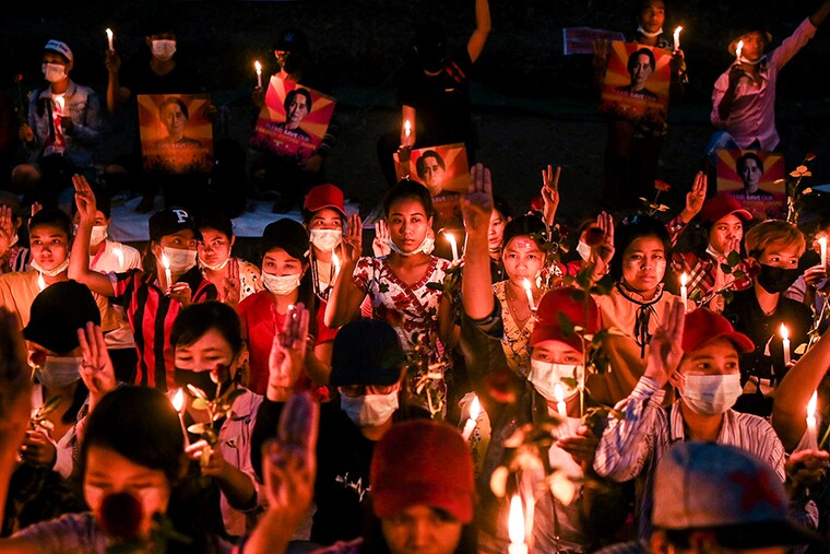 People gather during a candlelight vigil to protest against the military coup in Yangon, Myanmar, February 21, 2021.