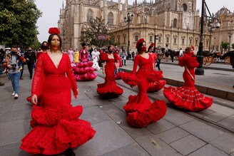 Women wearing flamenco dresses take part in a protest against the crisis in the flamenco fashion sector generated by the coronavirus pandemic, in Seville, Spain February 26, 2021.