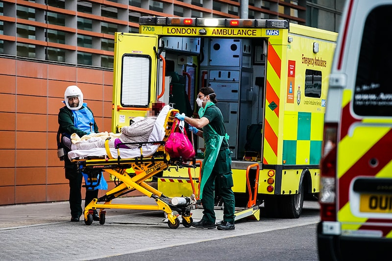 Paramedics transfer a patient from an ambulance into the Royal London Hospital, after Mayor of London Sadiq Khan declared a "major incident" as the spread of coronavirus threatens to "overwhelm" the capital"s hospitals.