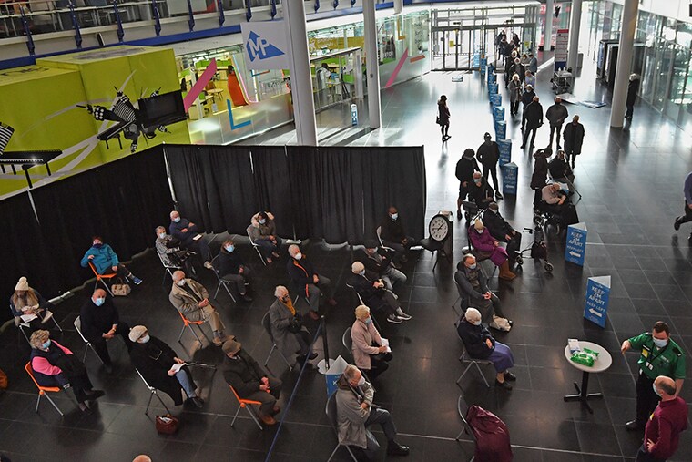 People waiting to receive an injection of a Covid-19 vaccine at the NHS vaccine centre that has been set up at the Millennium Point centre on January 11, 2021 in Birmingham, England. The location is one of several mass vaccination centres in England to open to the public this week. The UK aims to vaccinate 15 million people by mid-February.