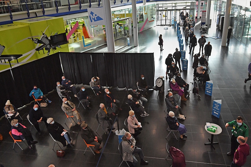 People waiting to receive an injection of a Covid-19 vaccine at the NHS vaccine centre that has been set up at the Millennium Point centre on January 11, 2021 in Birmingham, England. The location is one of several mass vaccination centres in England to open to the public this week. The UK aims to vaccinate 15 million people by mid-February.