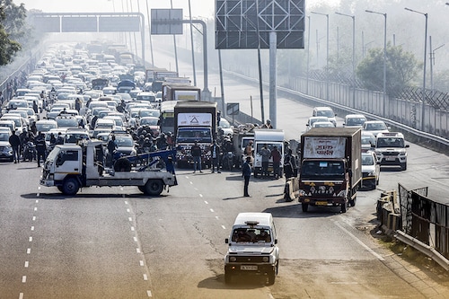 Traffic on NH48 is stopped momentarily as a temperature controlled truck carrying the Covid-19 vaccine is escorted by police on January 12, 2021 in New Delhi, India. The first batch of Covishield vaccine was delivered today in 13 Indian cities including Delhi, UP, Bihar Assam, Karnataka and Tamil Nadu by air as the country is set to launch a massive vaccination drive on January 16. As many as 1.3 billion people of the country are likely to get vaccinated during the drive, which officials described as the worlds biggest inoculation drive to fight against coronavirus that created havoc across the globe.