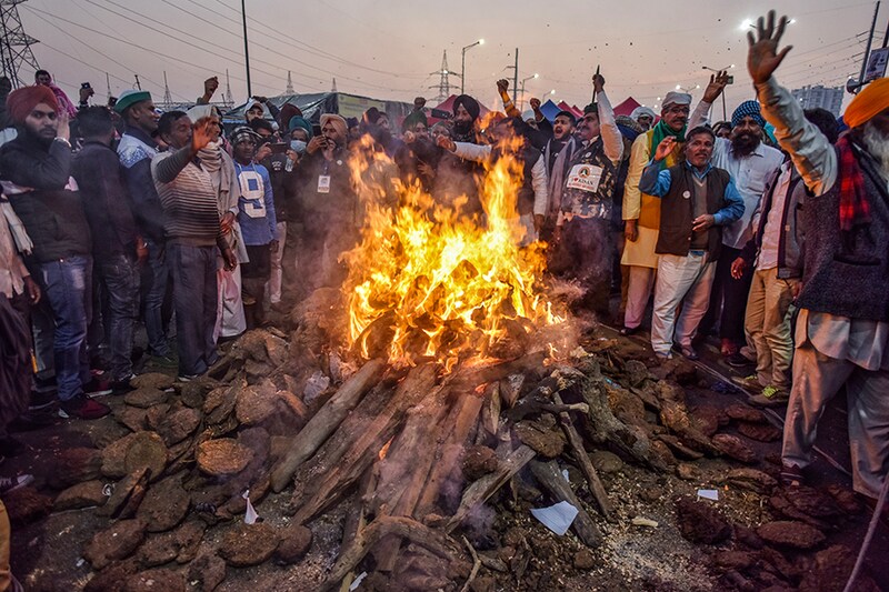 Farmers celebrate Lohri festival amid the ongoing protest against the new farm laws, at Ghazipur (Delhi-UP border) on January 13, 2021 in New Delhi, India.