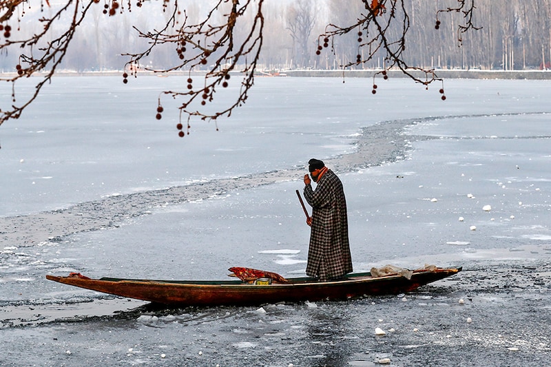 A man rows his boat on the partially frozen Dal Lake in Srinagar January 14, 2021. Across the Kashmir Valley and in the Srinagar mercury settling at minus 8.4°C, the lowest temperature of this winter so far and the coldest January nights in the last three decades.