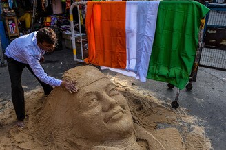 An artist gives final touches to a sand sculpture of Netaji Subhash Chandra Bose, in Kolkata, India, one of the pioneer freedom fighters of India, to commemorate his 125th birth anniversary celebrated today, January 23, 2021.