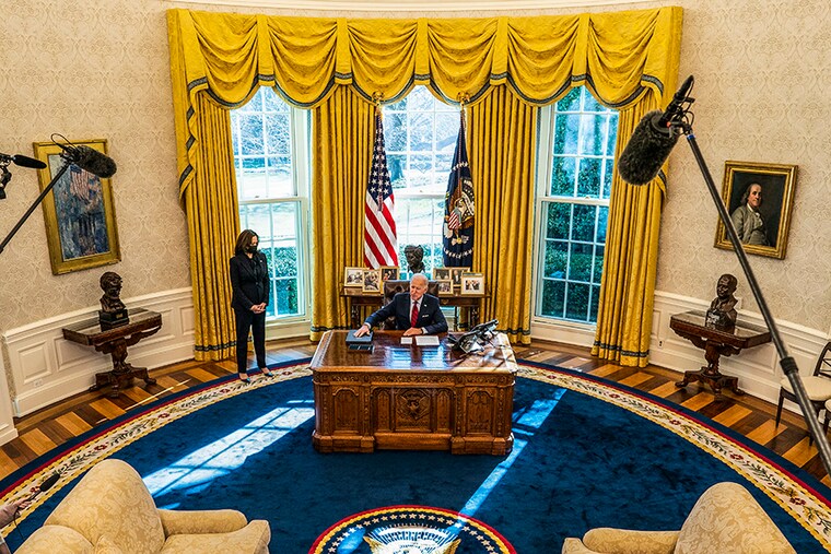 Vice President Kamala Harris looks on as U.S. President Joe Biden speaks to reporters before signing executive actions in the Oval Office of the White House on January 28, 2021 in Washington, DC. President Biden signed a series of executive actions Thursday afternoon aimed at expanding access to health care, including re-opening enrollment for health care offered through the federal marketplace created under the Affordable Care Act.