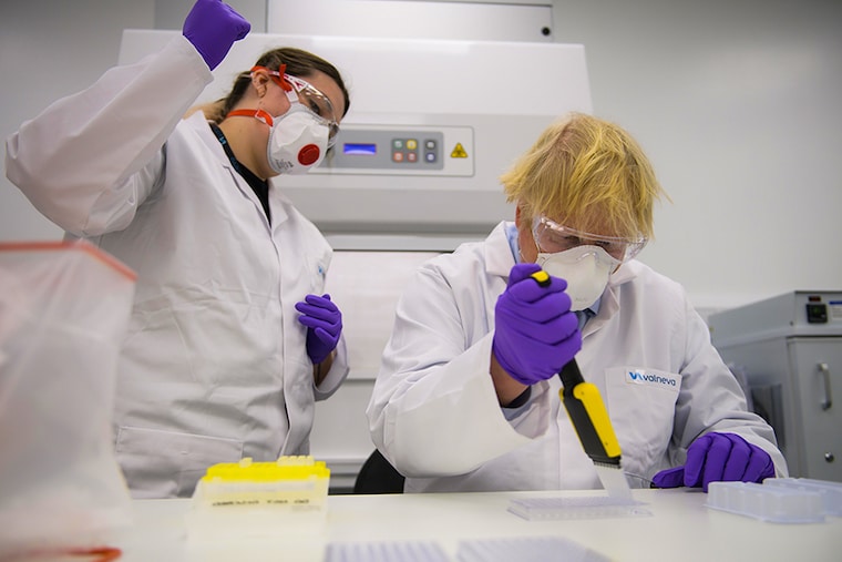 Boris Johnson tries his hand at one of the tests with Kerri Symington, quality control technician as he visits the French biotechnology laboratory Valneva in Livingston where they will be producing a Covid 19 vaccine on a large scale on January 28, 2021 in Livingston, Edinburgh, United Kingdom. Boris Johnson visits frontline keyworkers stating that there are great benefits of co-operating across the whole of the UK to beat the coronavirus pandemic. Opinion polls in Scotland show rising support for independence ahead of May"s Holyrood elections.