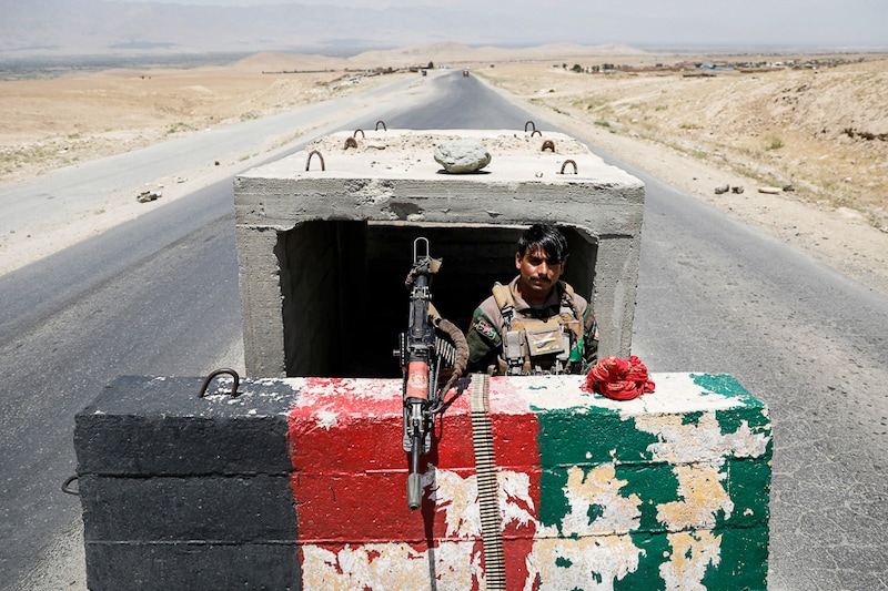 A lone Afghan National Army soldier stands guard at a checkpoint near Bagram U.S. air base, on the day the last of American and Nato troops vacated it amid Taliban surge, Parwan province, Afghanistan July 2, 2021. In the districts captured by the surging Taliban, violently ultra-conservative laws are returning, reviving dark memories of the 90s.