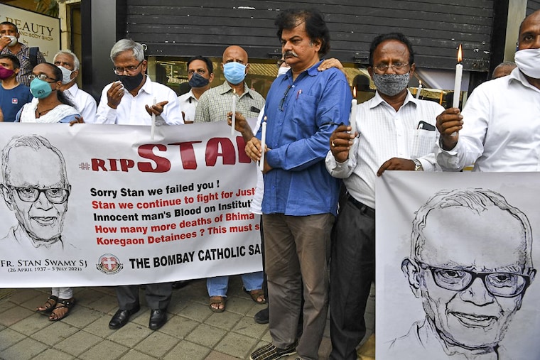 People gather outside a church holding memorial mass for the Indian rights activist and Jesuit priest Father Stan Swamy, in Mumbai on July 6, 2021. Father Stan was detained for nine months without trial under Indian anti-terrorism laws and died on July 5 ahead of a bail hearing.