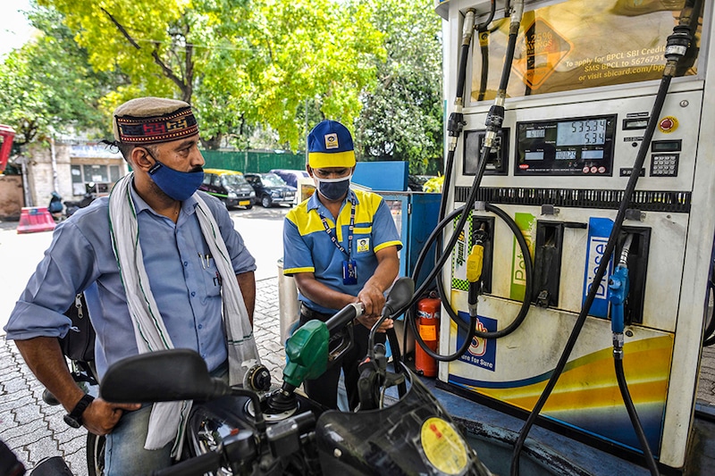 A worker refuels a motorbike at Janpath on July 7, 2021 in New Delhi, India. Petrol price per litre reached Rs 100.25 in New Delhi.