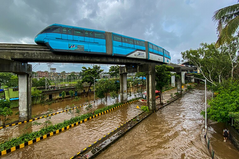 A view of the Mumbai Monorail as it passes by while the streets are flooded due to heavy rains near Wadala Monorail station in Mumbai