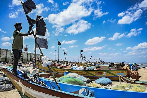 A fisherman hoists a black flag in Chennai as a sign of protest against the Indian Marine Fisheries Bill 2021.